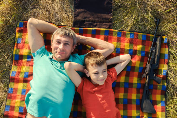 istock Father and son resting on a plaid 1251324433