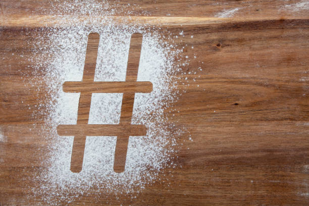 Hashtag symbol stencil in flour on a wooden board