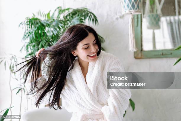 Young Adult Female Spending Free Time At Home Stock Photo - Download Image Now - Hair, Women, Hair Care