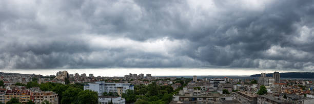 istock Panorama of dark thunderstorm sky hovering over Varna. Dramatic cloudscape over seaside city. Scenic stormy clouds on a summer day. 1251326235
