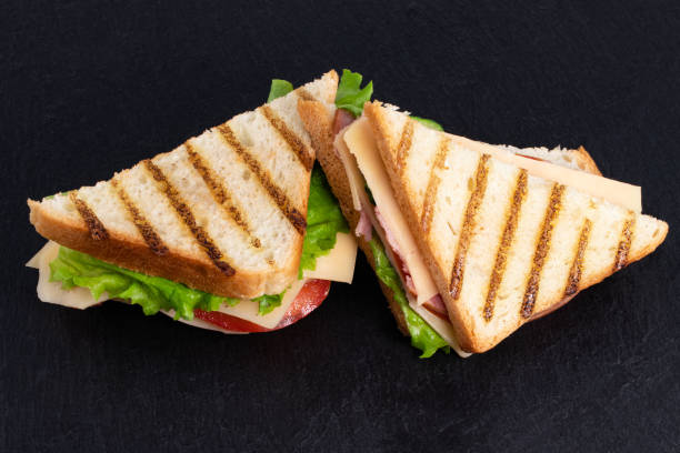 istock sandwich with ham and lettuce and cheese on a dark background with copy space 1251326250