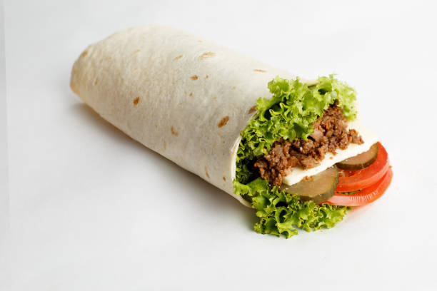 istock Hot roll with chopped meat, lettuce, cucumber and tomatoes. Close-up 1251326979