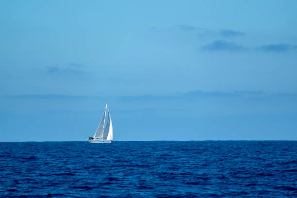 istock small sailboat on deep blue sea 1251328862