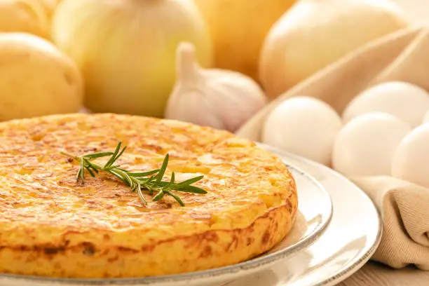 Photo of Spanish omelette with potatoes and onion, typical Spanish cuisine.