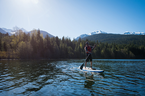 Paddleboarding in Whistler, Canada. Canada's top tourist destiantions. Green Lake in Whistler, BC, Canada.