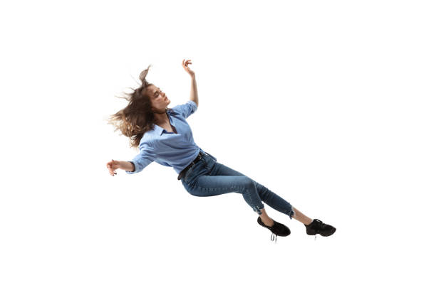 Mid-air beauty. Full length studio shot of attractive young woman hovering in air and keeping eyes closed Mid-air beauty cought in moment. Full length shot of attractive young woman hovering in air and keeping eyes closed. Levitating in free falling, lack of gravity. Freedom, emotions, artwork concept. floating woman stock pictures, royalty-free photos & images