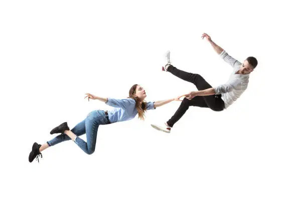 Photo of Mid-air beauty. Full length studio shot of attractive young woman and man hovering in air and keeping eyes closed