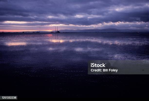 Dublin Bay Viewed From Dollymount Strand At Night Stock Photo - Download Image Now - Chimney, Dramatic Sky, Horizontal