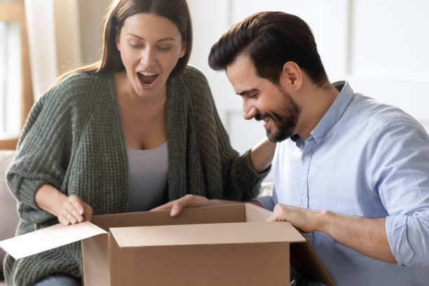 istock Excited surprised woman looking into cardboard box, receive parcel 1251332417