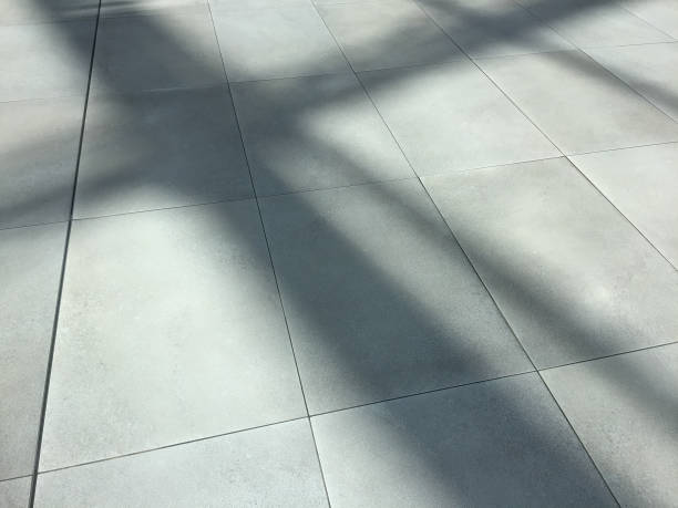 istock Clean ceramics tiled floor with sunlight and shadow 1251332458