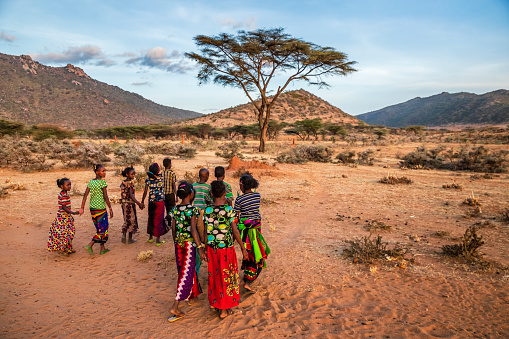 Group of happy African children crossing savannah - Ethiopia, East Africa