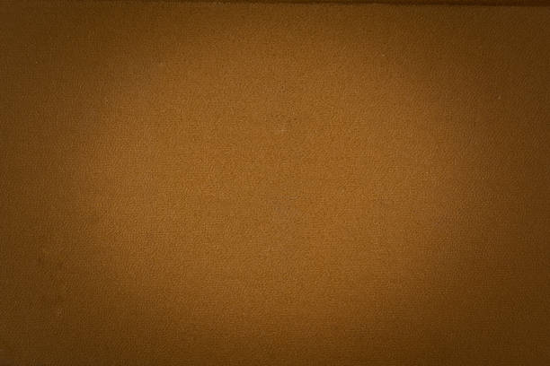 istock abstract brown background  paper with bright center spotlight and black vignette border frame with vintage 1251335236
