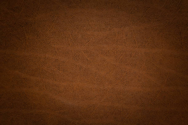 istock abstract brown background  paper with bright center spotlight and black vignette border frame with vintage 1251335242