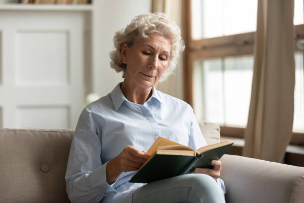 istock Middle-aged 50s woman spend free time reading a book 1251337457