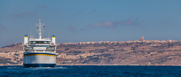 A picture of a ferry crossing the waters between the main island of Malta and Gozo.