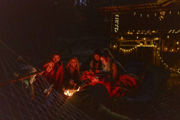 istock Friends enjoying by the campfire 1251338849