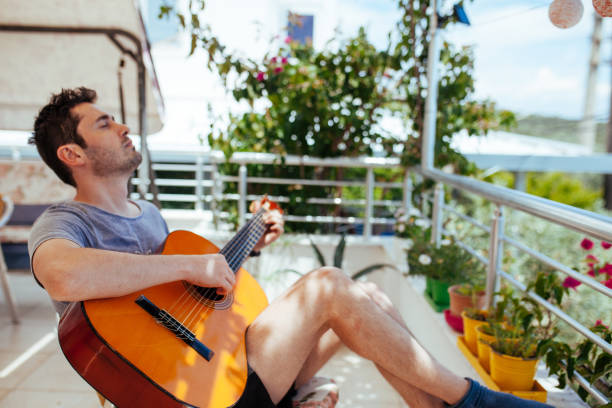 Man Playing Guitar and Singing stock photo