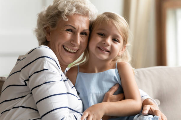 istock Granddaughter spend time pose for camera with elderly cheerful grandmother 1251339057