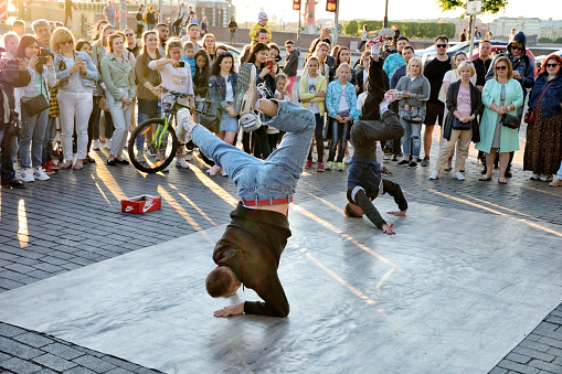 St. Petersburg. Russia. June 20.2020.The guys are dancing break dance on the street.They gather around them spectators.And demonstrate their skills in dance.