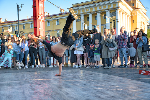 St. Petersburg. Russia. June 20.2020.The guys are dancing break dance on the street.They gather around them spectators.And demonstrate their skills in dance.