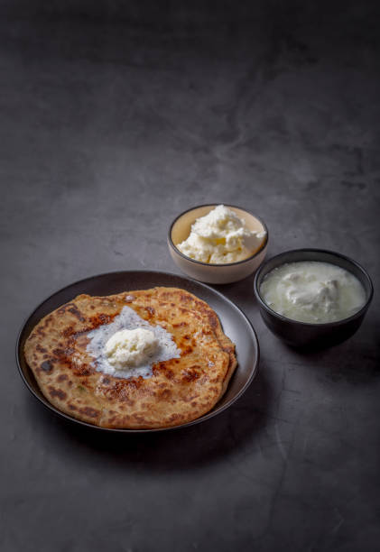 istock Aloo paratha or stuffed potato flatbread with curd and white butter 1251340080