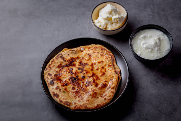 istock Aloo paratha or stuffed potato flatbread with curd and white butter 1251340108