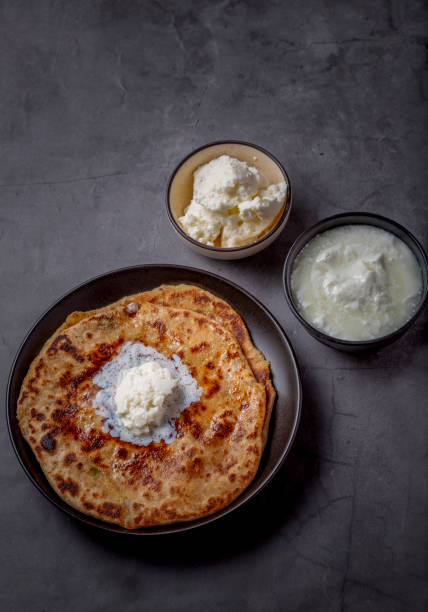 istock Aloo paratha or stuffed potato flatbread with curd and white butter 1251340128