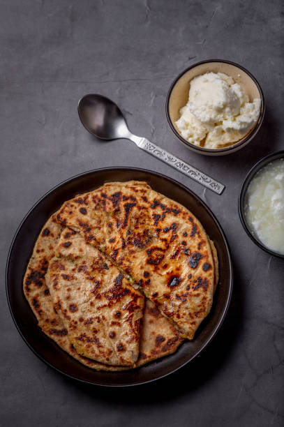 istock Aloo paratha or stuffed potato flatbread with curd and white butter 1251340198