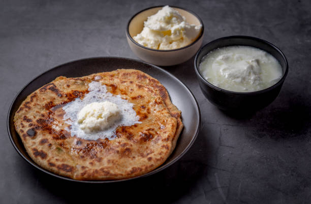 istock Aloo paratha or stuffed potato flatbread with curd and white butter 1251340807