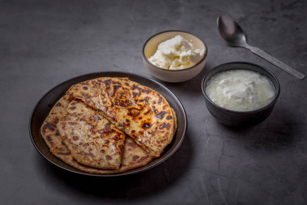 istock Aloo paratha or stuffed potato flatbread with curd and white butter 1251340818