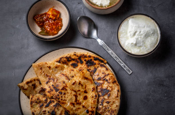 istock Aloo paratha or stuffed potato flatbread with curd, white butter and mango pickles 1251341402