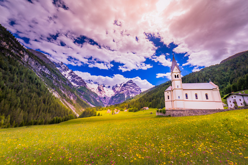 Church and village above Idyllic Italian alps landscape, near Passo dello Stelvio, Italy