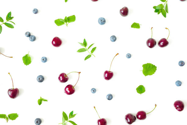 istock Swet cherry and blueberry with mint on white. Top view. Flat lay berry pattern 1251341551