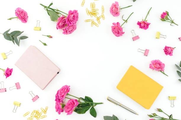 istock Frame composition with notebook, pen and roses on white background. Flat lay. 1251341611