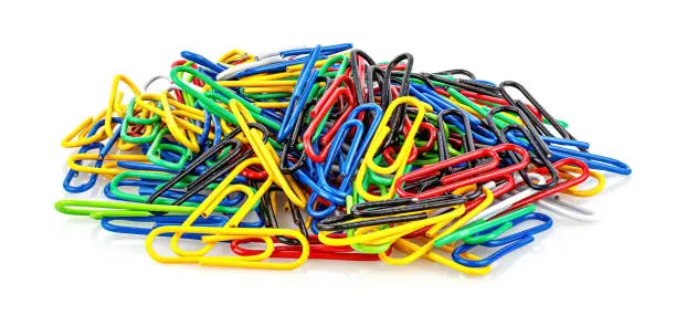 Photo of Bunch of paper clips in colored plastic shells isolated on white background