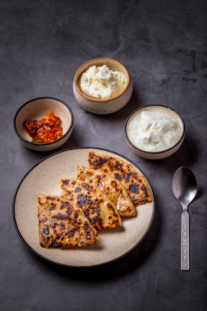 istock Aloo paratha or stuffed potato flatbread with curd, white butter and mango pickles 1251342048