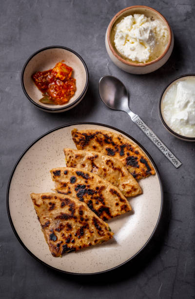 istock Aloo paratha or stuffed potato flatbread with curd, white butter and mango pickles 1251342076