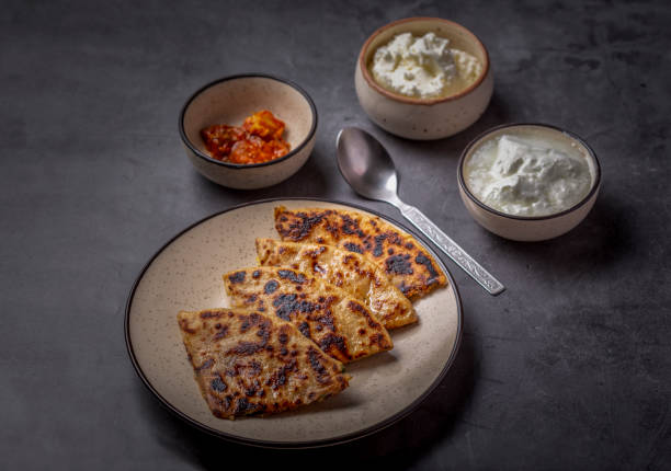 istock Aloo paratha or stuffed potato flatbread with curd, white butter and mango pickles 1251342110