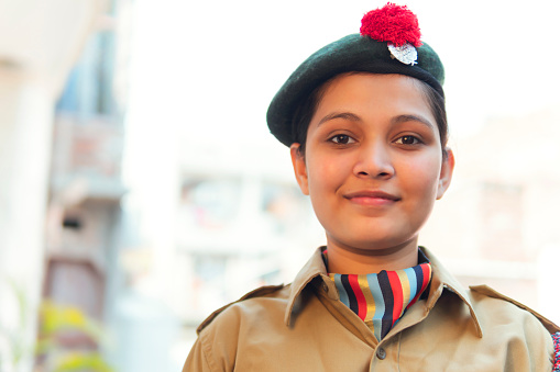Indian Portrait of happy young girl wearing NCC uniform.outdoor shoot . copy space.