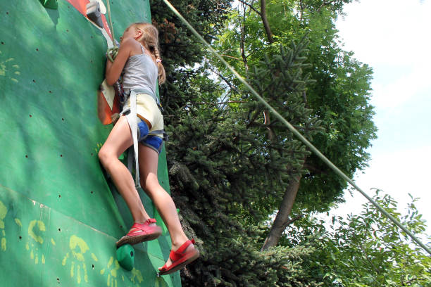 istock girl climbs a climbing wall in the park 1251344977