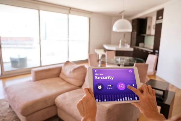 istock Woman controlling security system with a digital tablet at home 1251345669