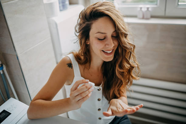 Young woman paints her nails