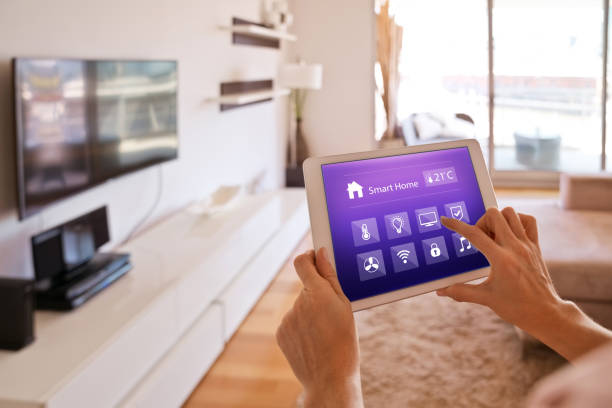 istock Woman controlling smart devices with a digital tablet at home 1251345849