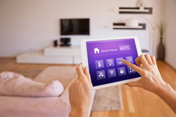 istock Woman controlling smart devices with a digital tablet at home 1251345920