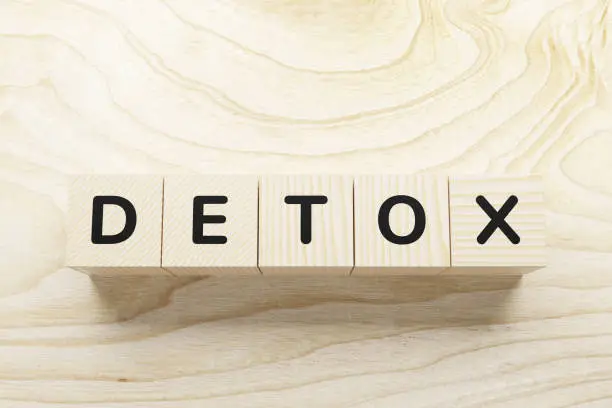 Photo of DETOX word written in wooden blocks.