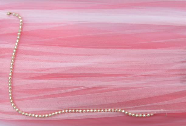 Pearls on Pink-Peach-White Variegated Background. Copy Space. Background.