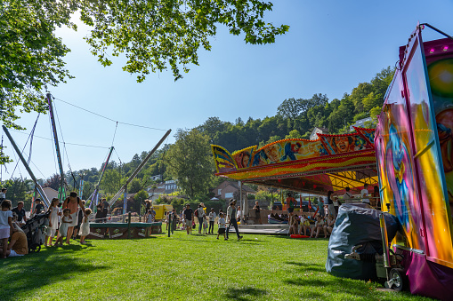 Fairground at Schützenmatt at sunny summer day with children on the 4th of july at Jugendfest Brugg 2019.