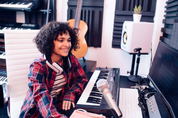 istock Happy female musician composing in her studio 1251347011