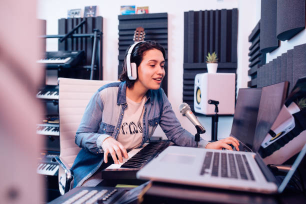 istock Happy musician playing and singing in the studio 1251347020