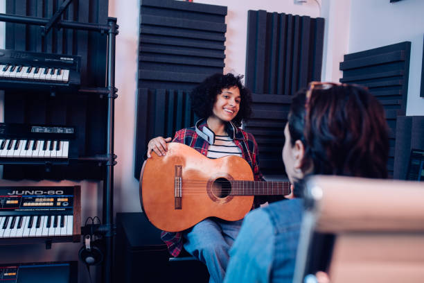 istock Two girls working in the music studio 1251347041